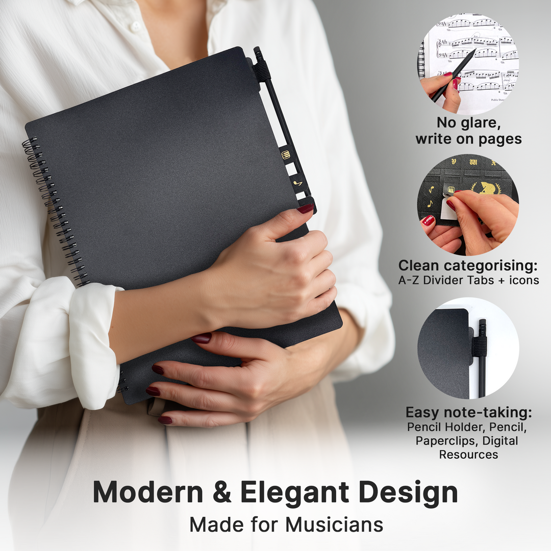 Person holding a black notebook with features highlighted for musicians on a gray background